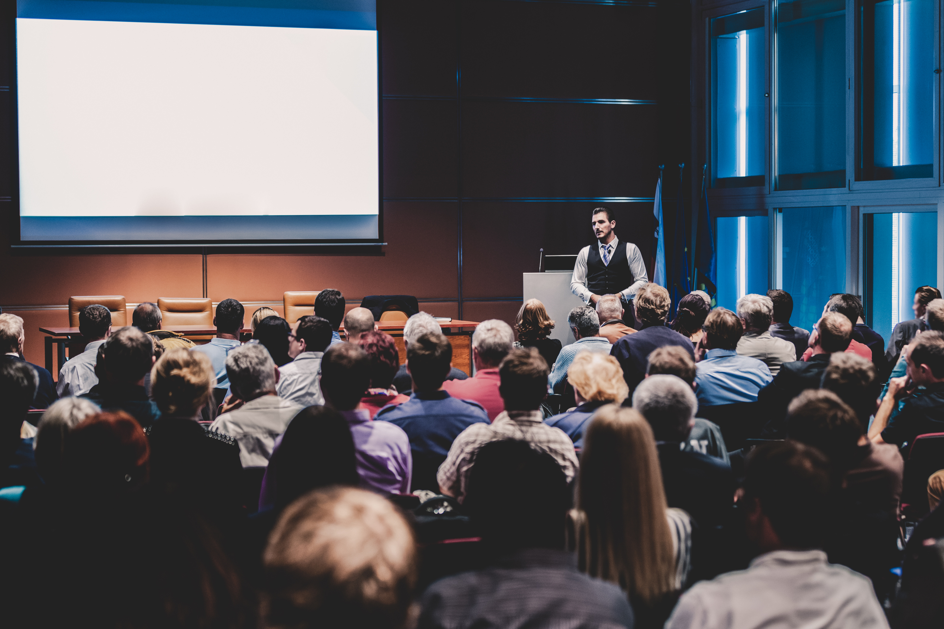 Business Speaker Giving a Talk at Business Conference 