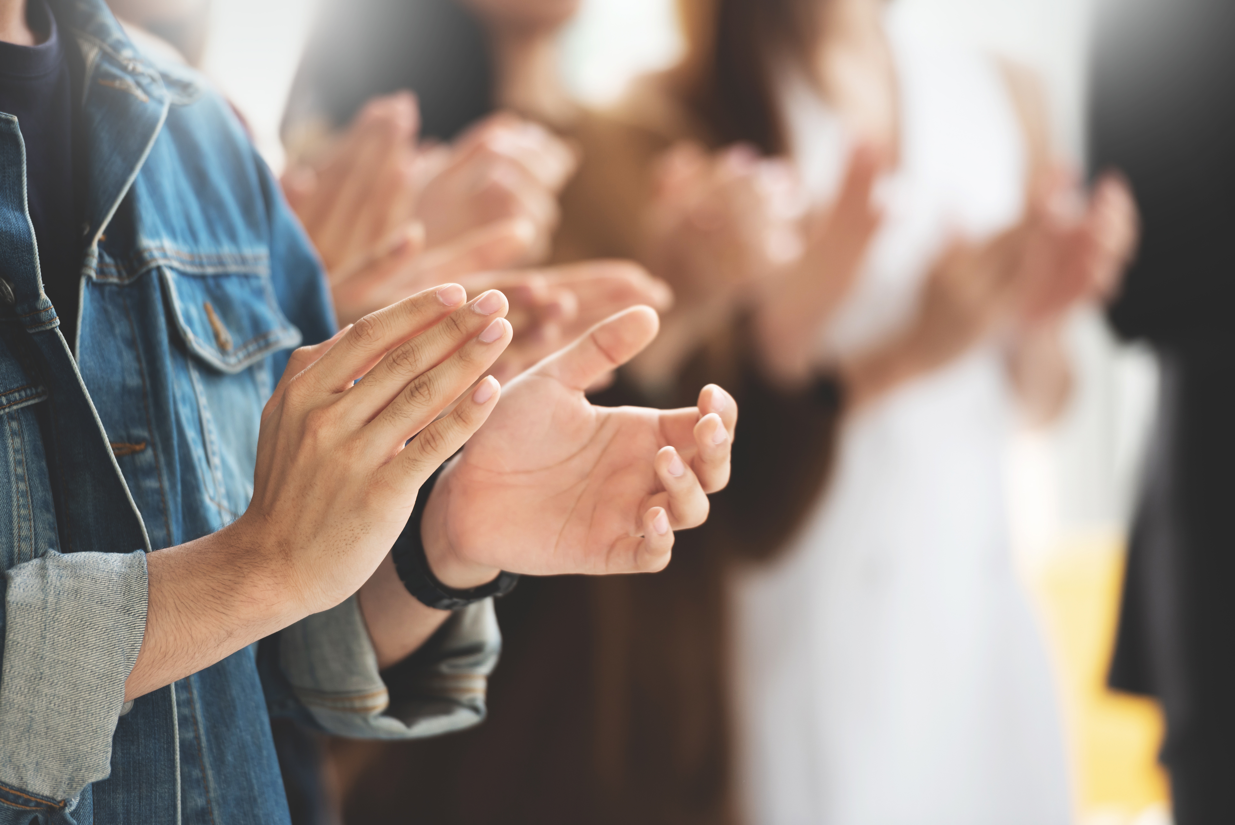 Cropped image of Creative designers audience applauding at a business seminar.