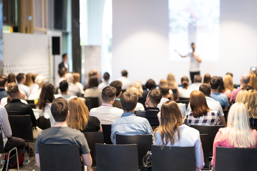 Business Speaker Giving a Talk at Business Conference Event.